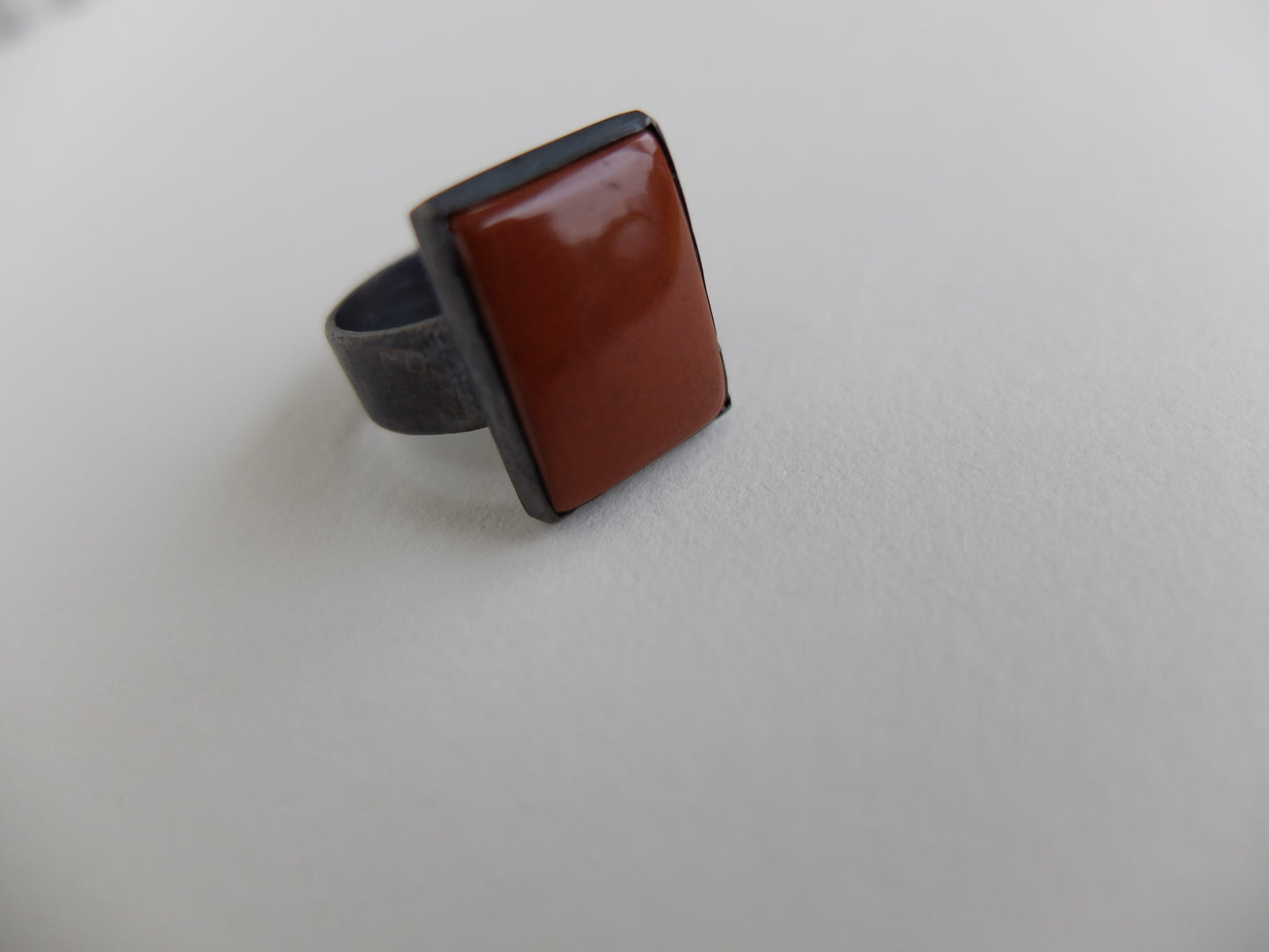 Ring with a brown square stone on a light gray background