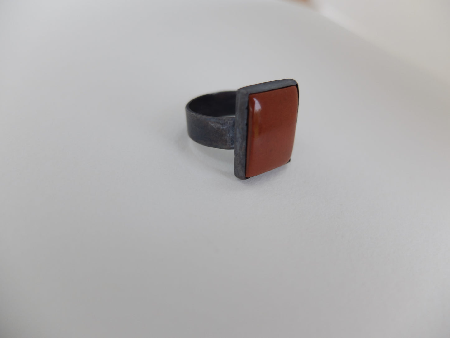 Ring with a brown square stone on a light gray background