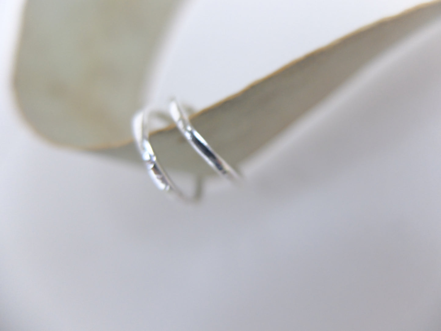 Silver hoop earrings on a white background