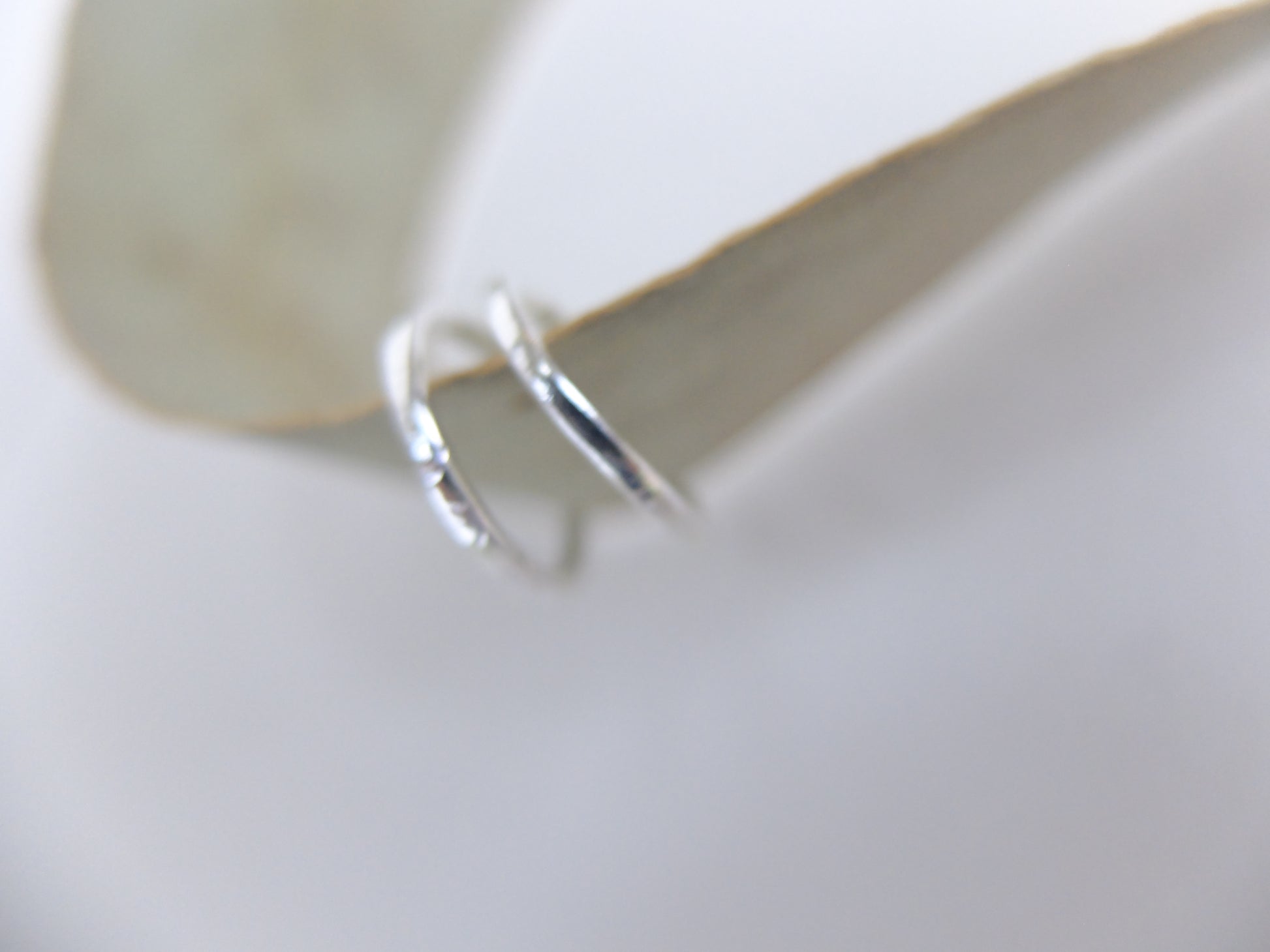 Silver hoop earrings on a white background