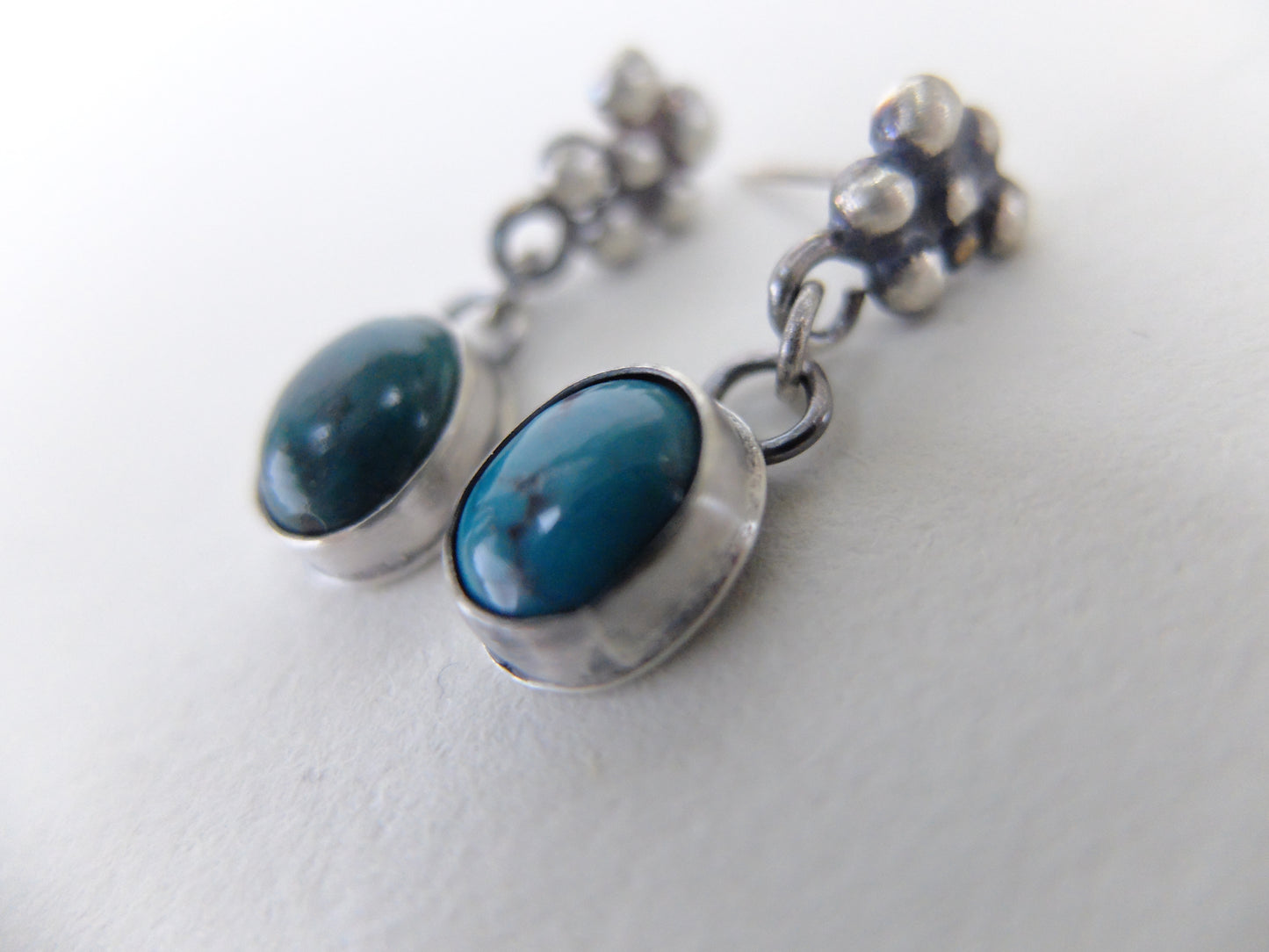 Pair of earrings with blue stones on a white background