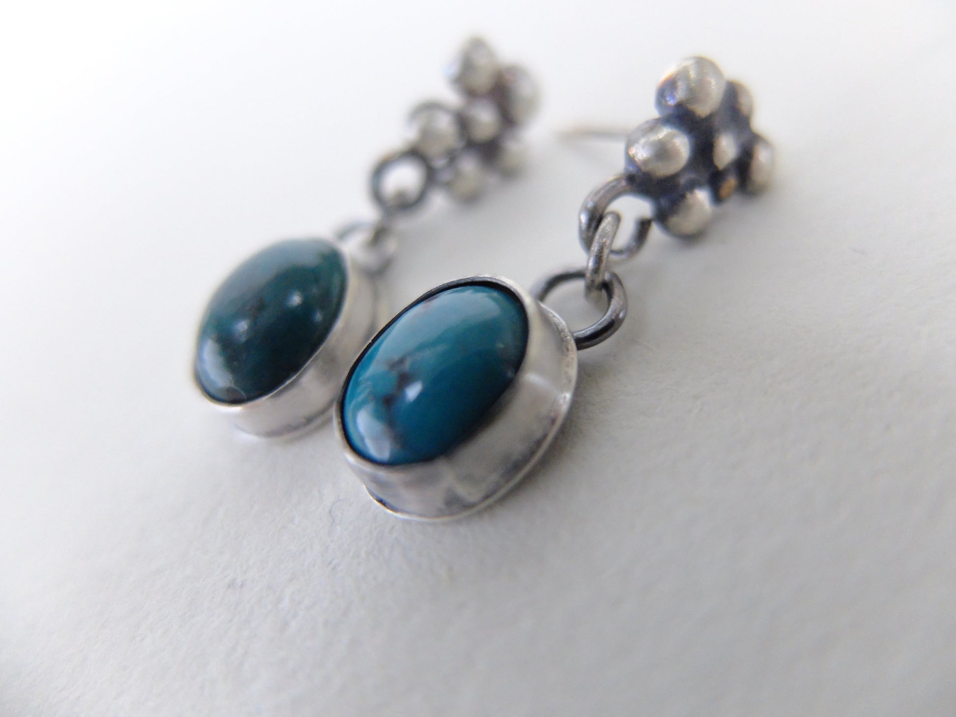Pair of earrings with blue stones on a white background