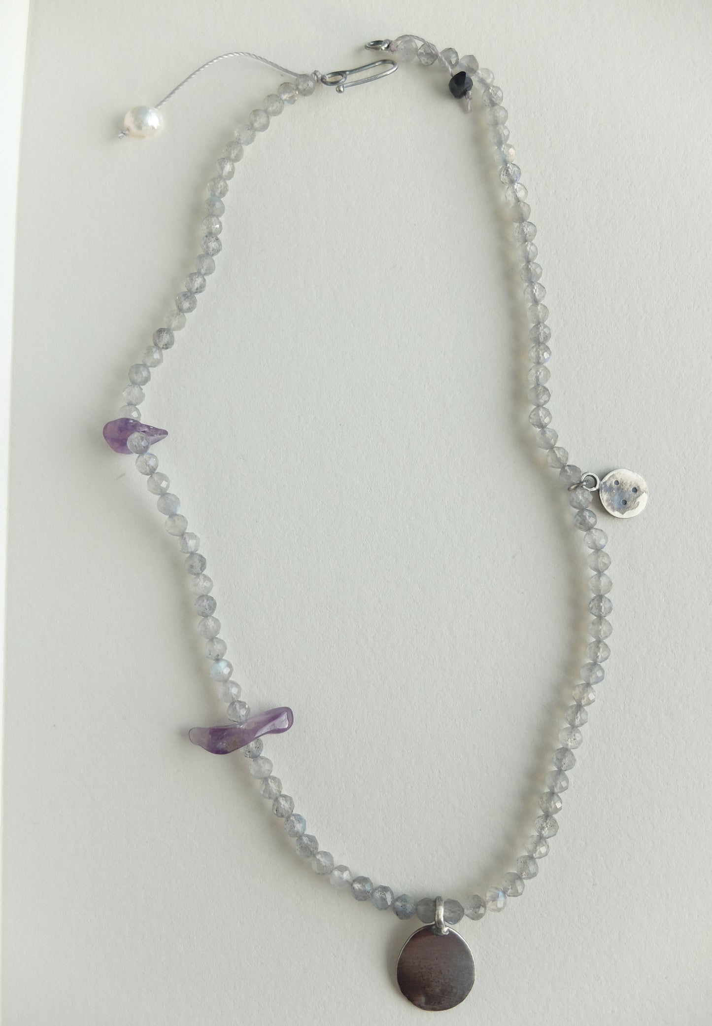 Labradorite Beaded necklace with purple Amethyst accents on a light grey background