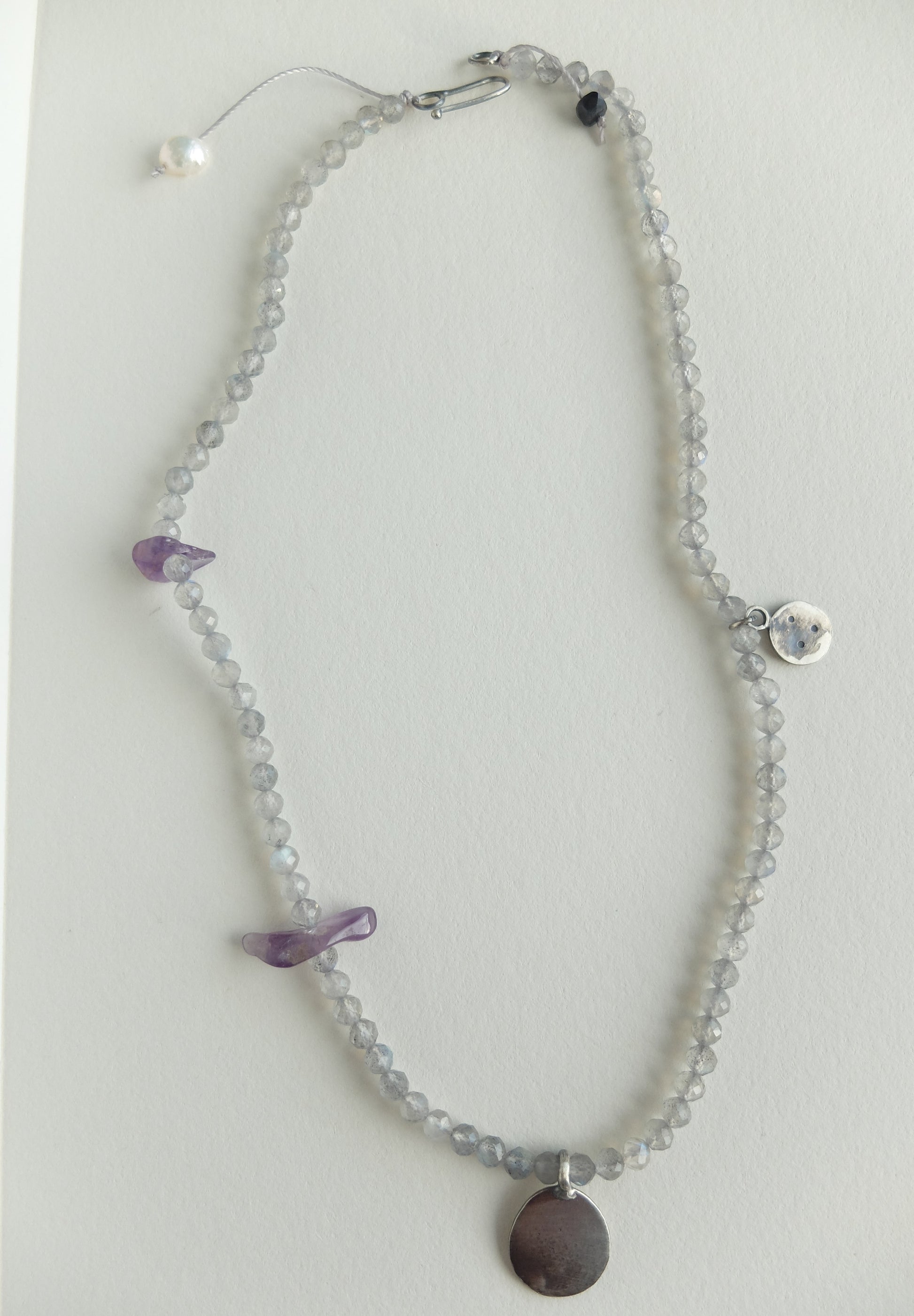 Labradorite Beaded necklace with purple Amethyst accents on a light grey background