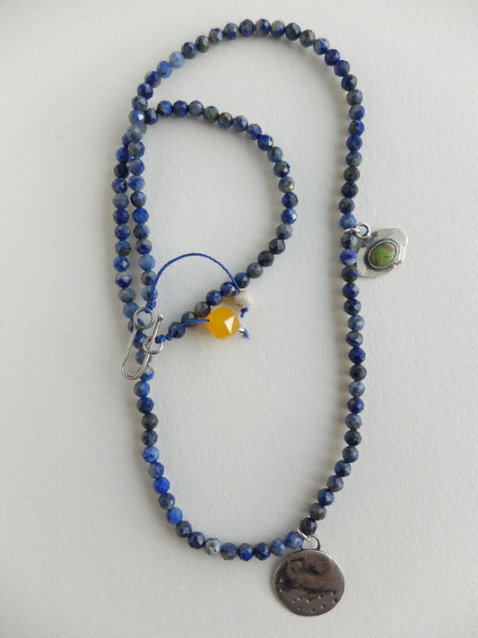 Beaded necklace with various colored beads on a white background
