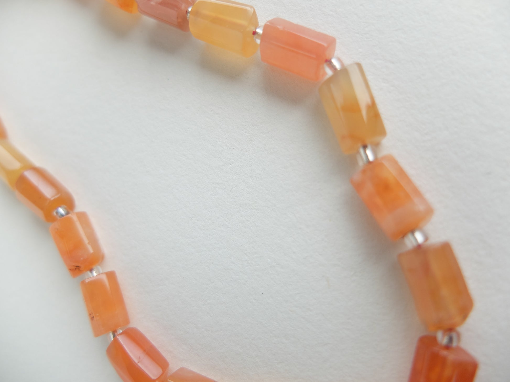 Necklace with orange beads on a white background